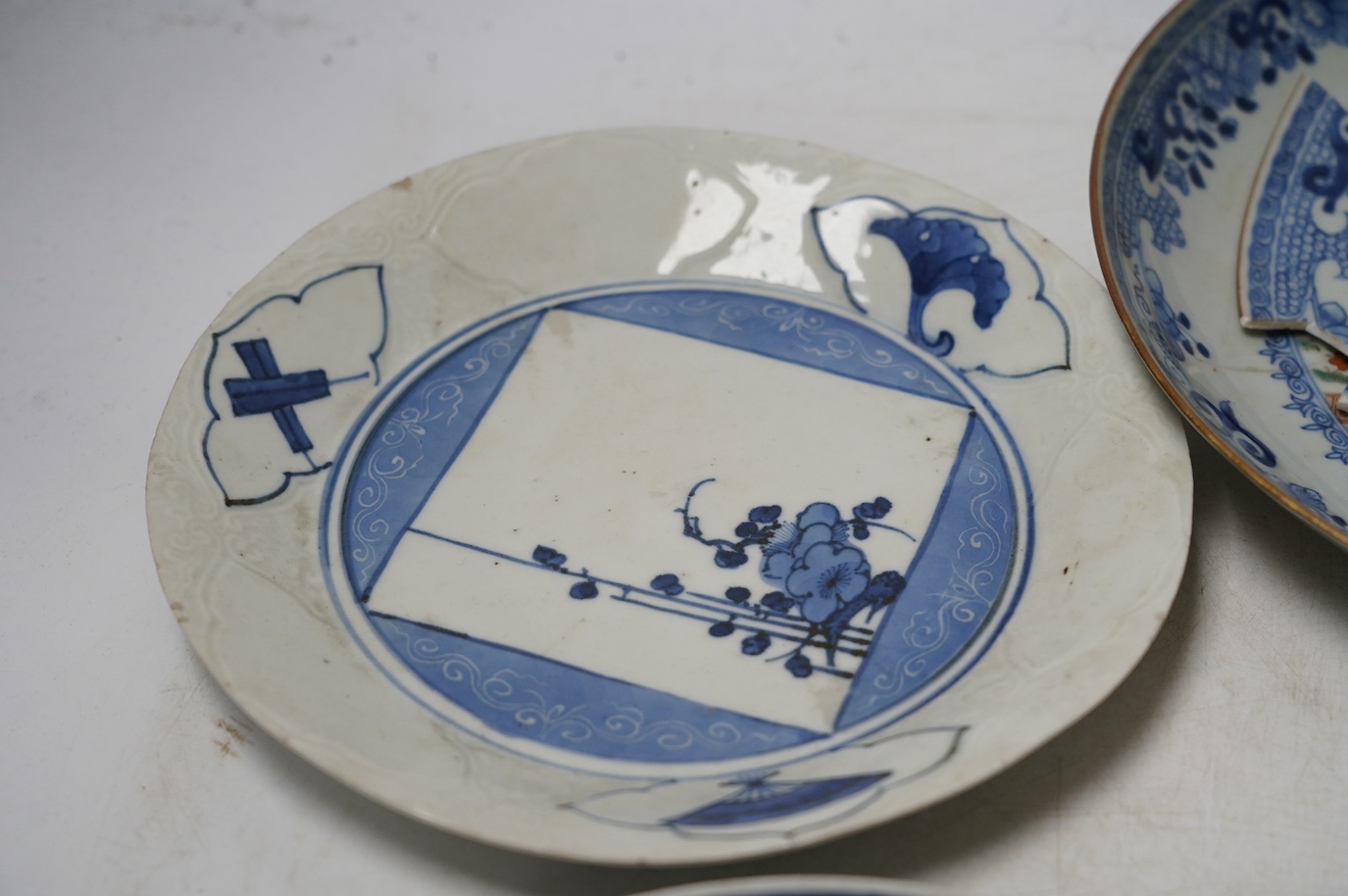 Three Japanese Kakiemon style blue and white dishes and an 18th century Chinese famille rose dish. Condition - varies